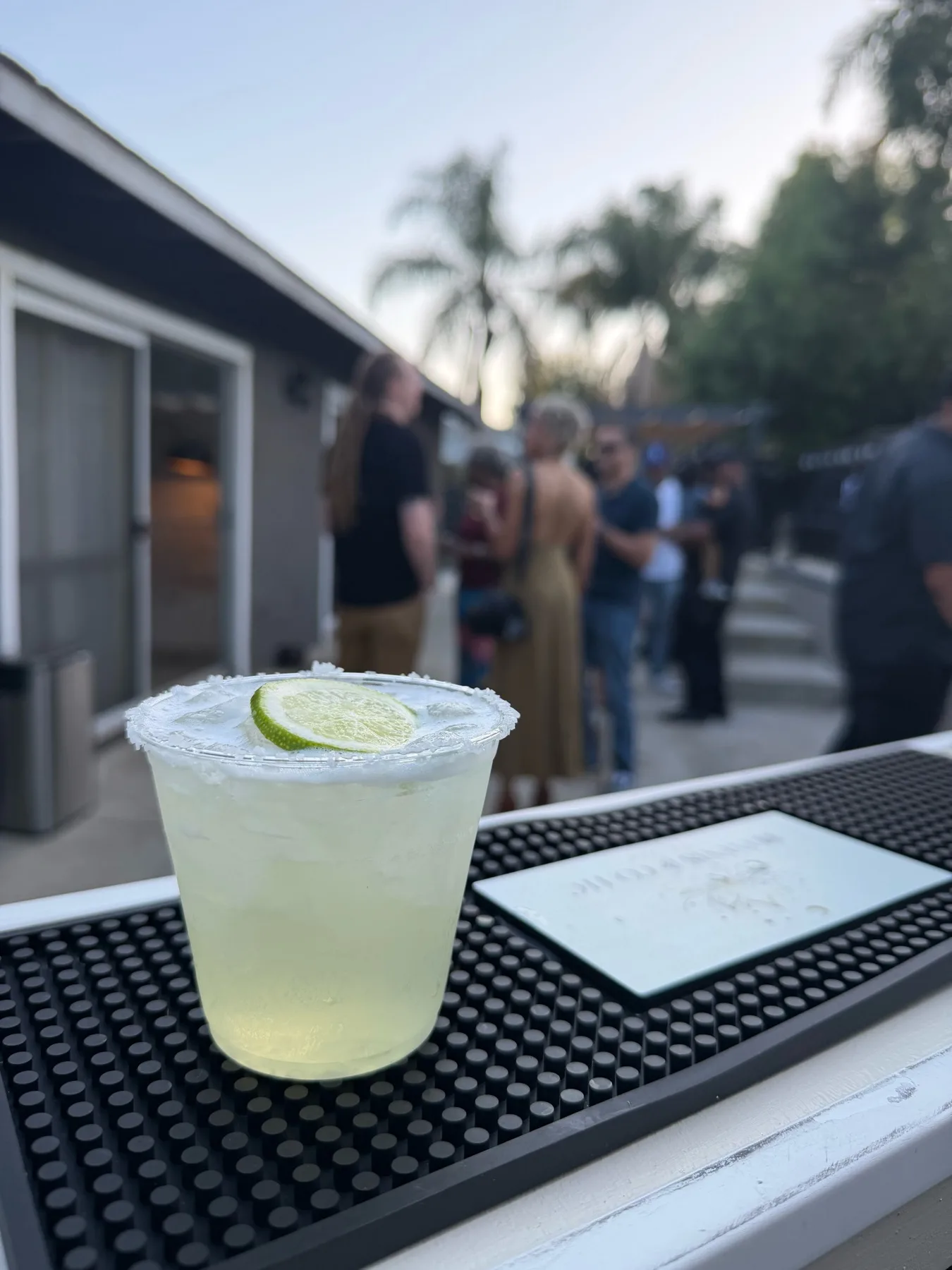 Cocktail on a mobile bar with guests in the background