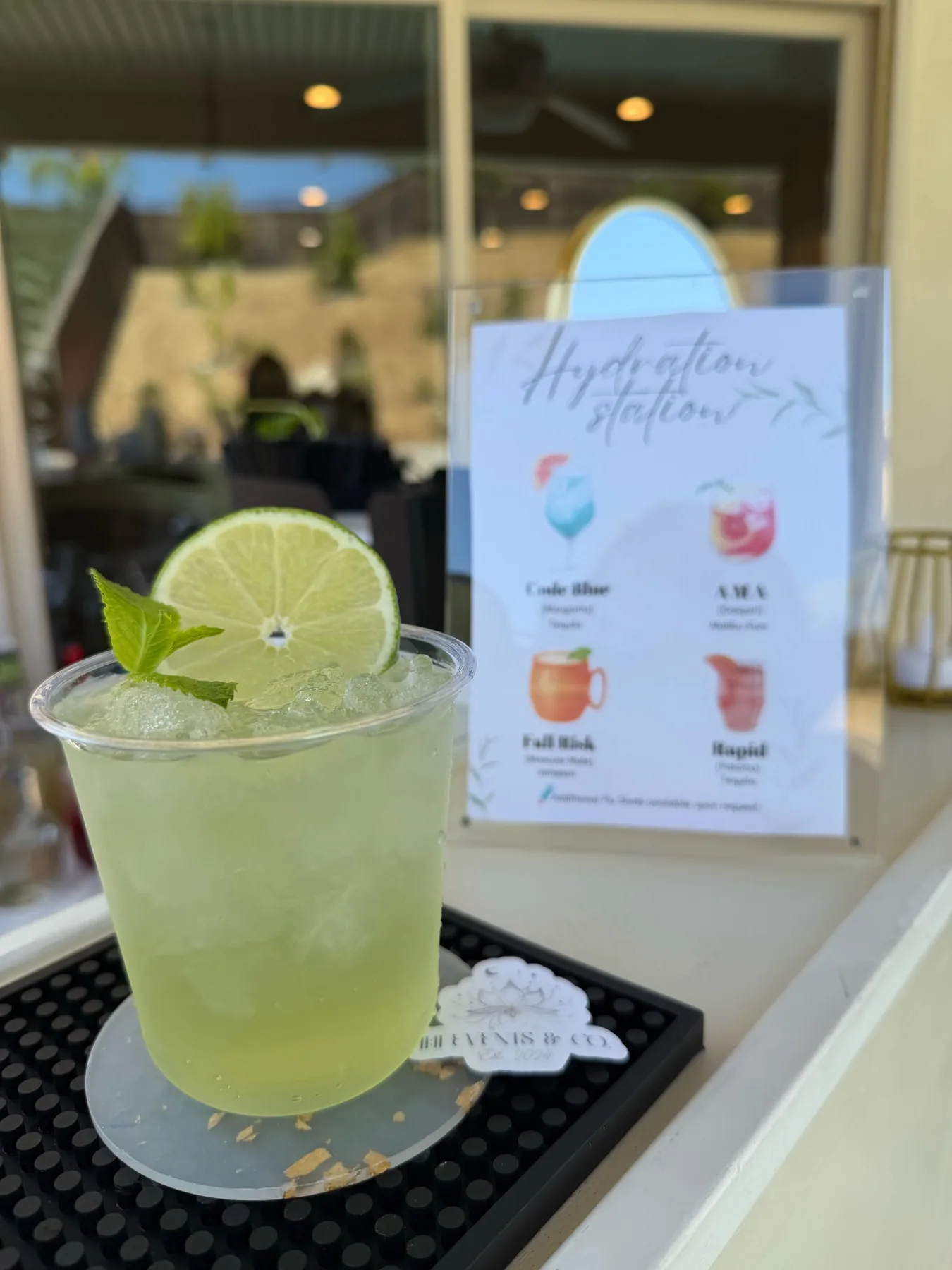 Lime cocktail beside a custom event menu
